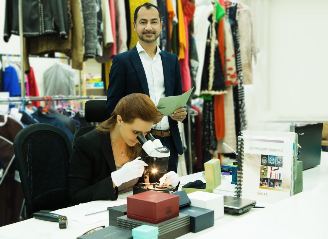 The Luxury Closet CEO Kunal Kapoor with a staff member checking the authenticity of an item.