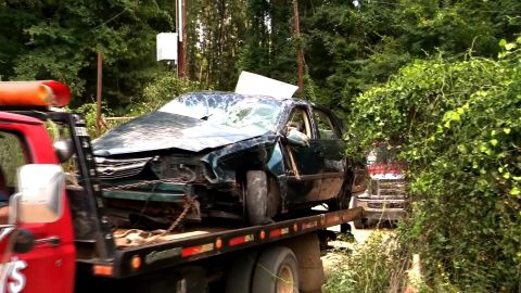 A tow truck transports the wrecked car found near Camden, Arkansas.