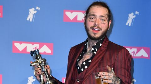 Rapper Post Malone holds his award for song of the year at the 2018 MTV Video Music Awards in New York on Monday.