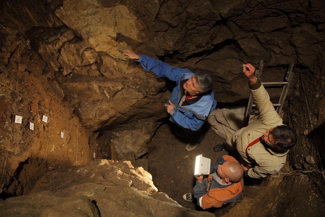 Richard Roberts, Vladimir Ulianov and Maxim Kozlikin (clockwise from top) in the East Chamber of Denisova Cave, Russia. 