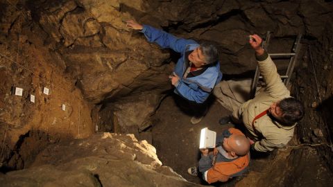 Richard Roberts, Vladimir Ulianov and Maxim Kozlikin (clockwise from top) in the East Chamber of Denisova Cave, Russia. 