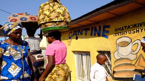Women make their way to a morning market in Kigali.