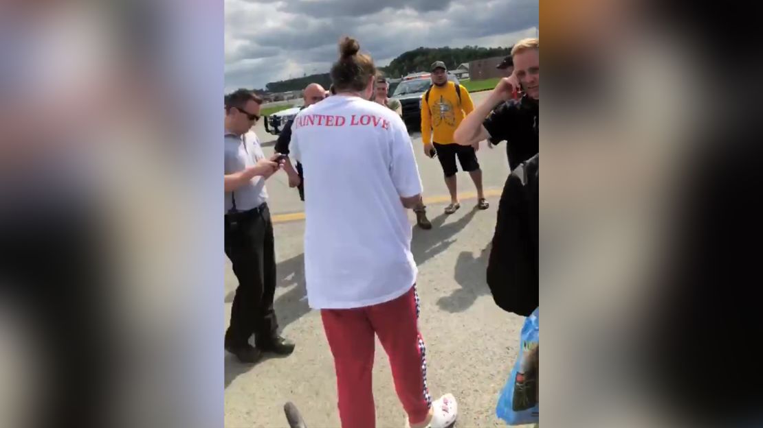 Post Malone stands on the tarmac after the plane's emergency landing.