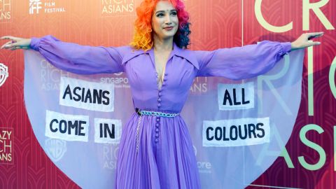 Burlesque performer Sukki Singapora poses for photographers as she arrives for the red carpet screening of "Crazy Rich Asians."