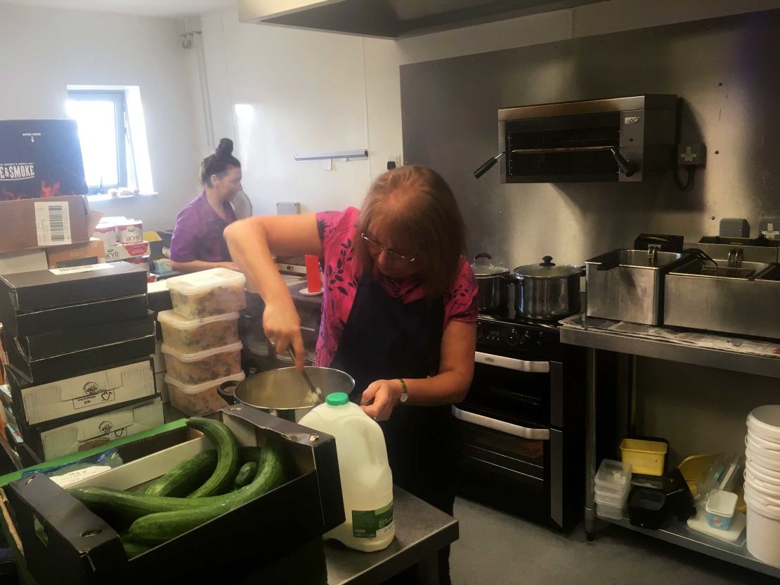 Dianne Williams mashes potato in preparation for lunchtime.