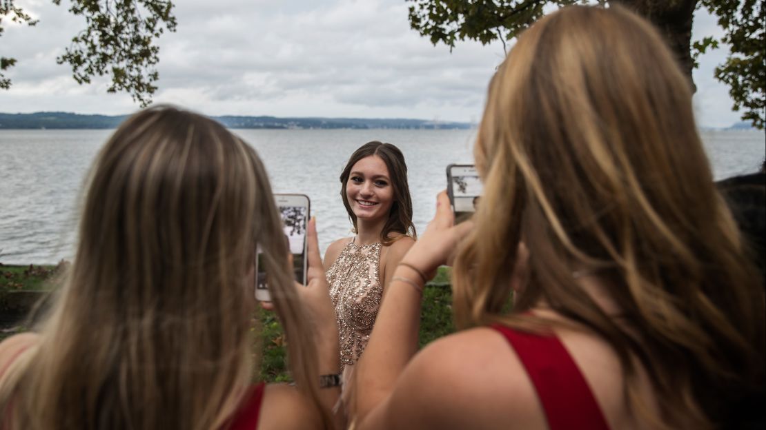Cara poses for pictures outside the banquet hall at Nyack Beach State Park as friends snap photos. "You look like a princess," one friend says.