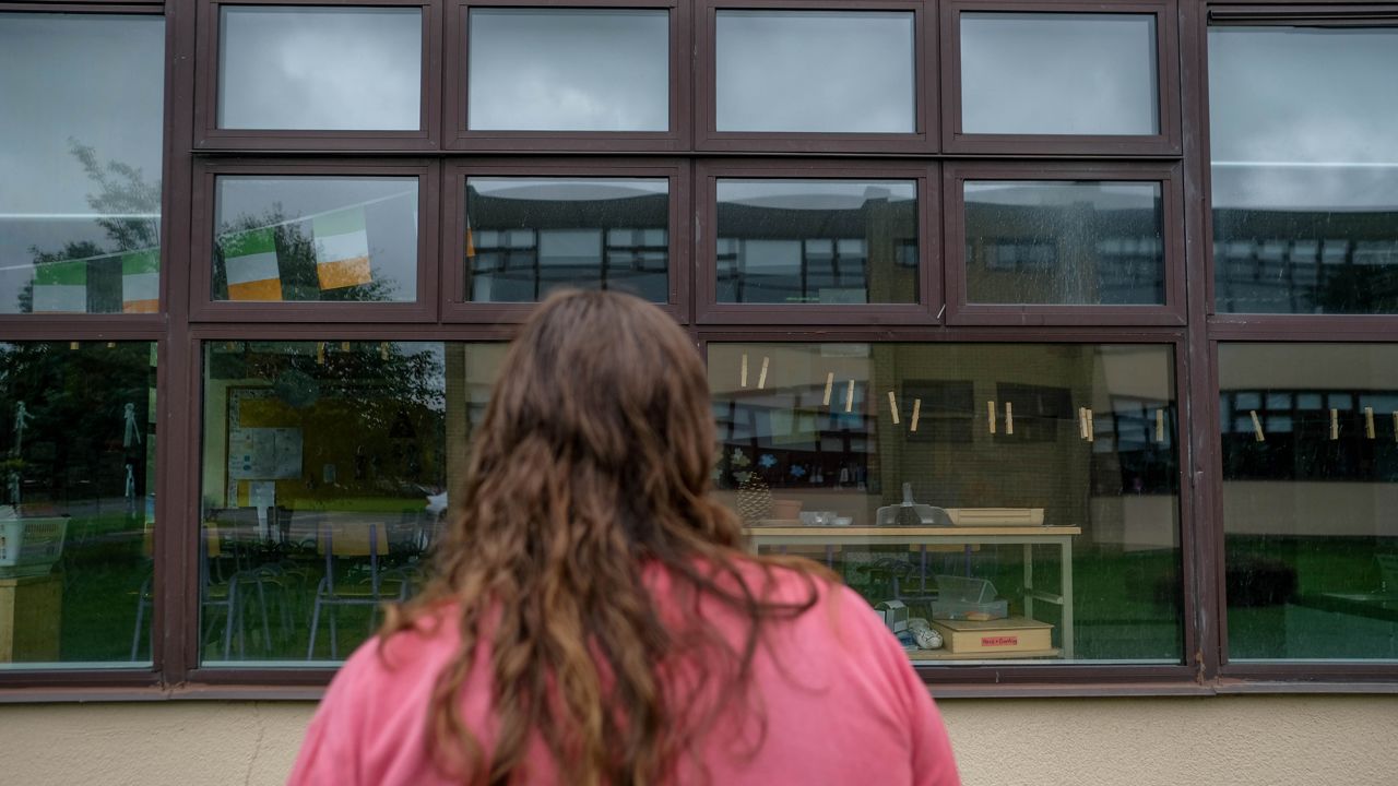 Matthews stands outside of a Catholic primary school closer to her home.