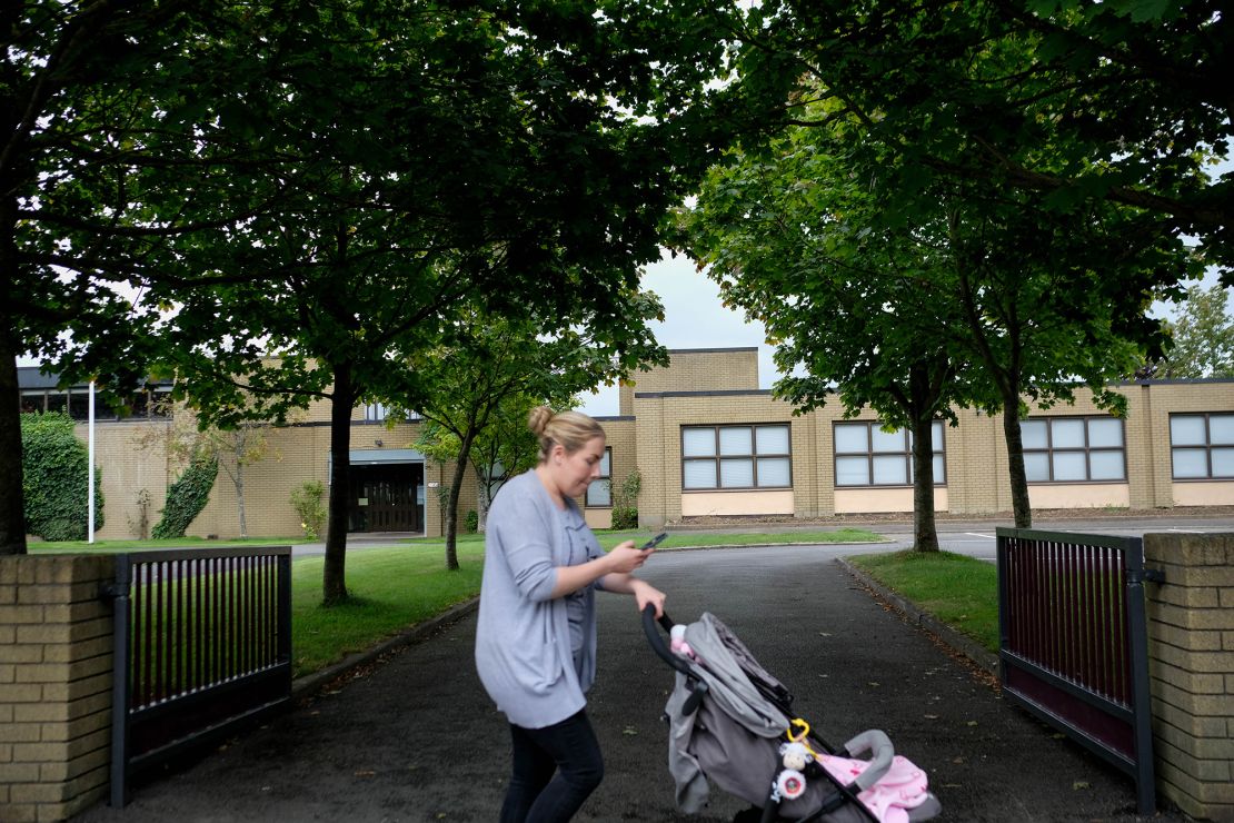A woman passes one of three Catholic primary schools on Leixlip's Green Lane.
