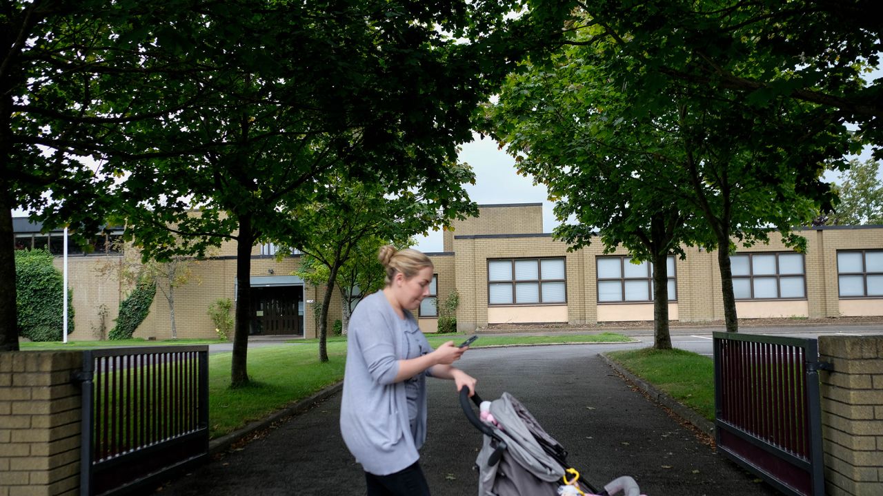 A woman passes one of three Catholic primary schools on Leixlip's Green Lane.