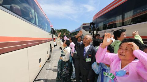 North Koreans wave farewell to their South Korean relatives (in the bus) after a three-day family reunion event at North Korea's Mount Kumgang resort on August 22, 2018.