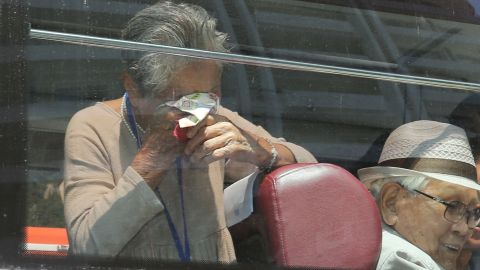 South Korean Lee Keum-seom (L), 92, reacts as she bids farewell through the window to her North Korean son Ri Sang Chol, 71.