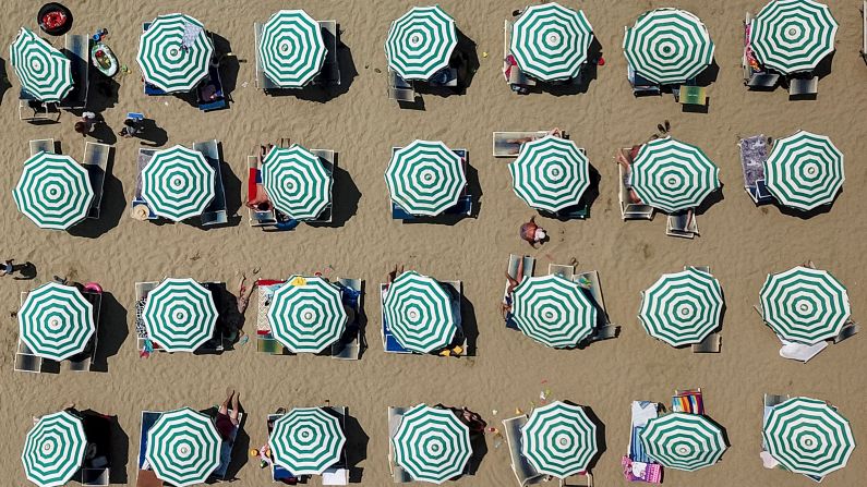 <strong>Durrës, Albania: </strong>Parasols dot a beach in the port city of Durrës on the Adriatic Sea. Beach-goers made the most of the summer heatwave sweeping Europe and beyond. <br />