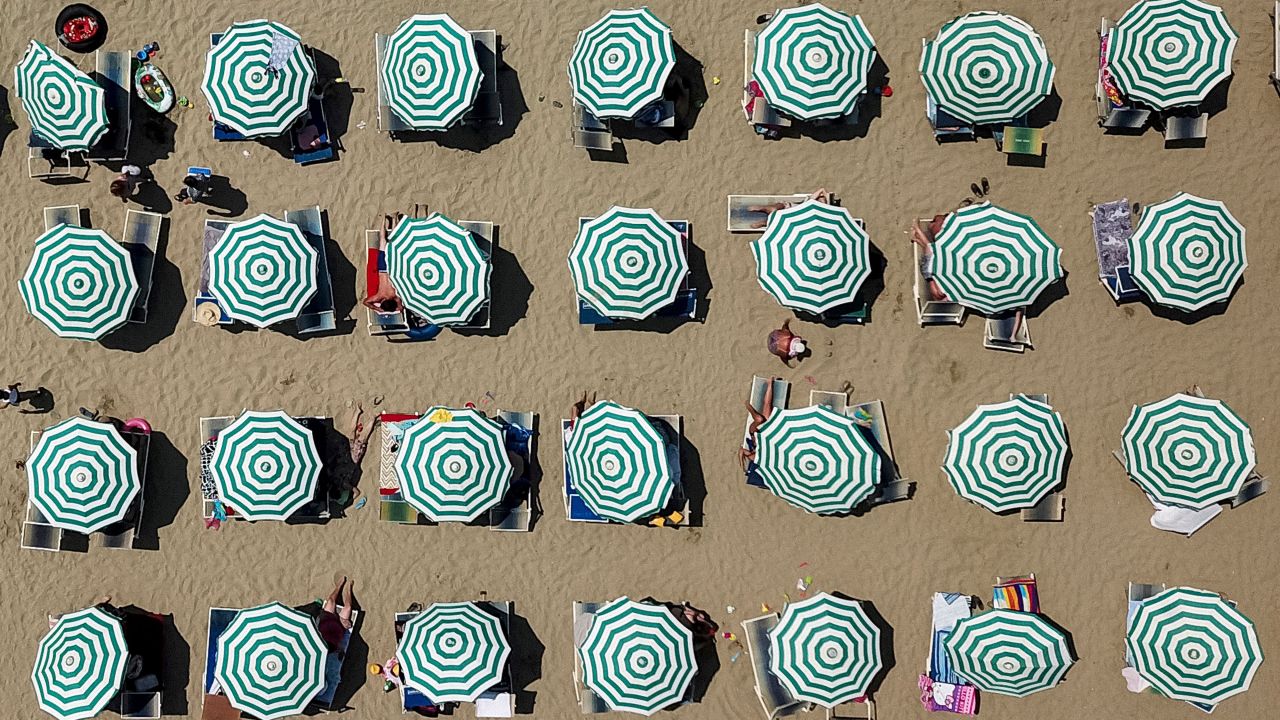 <strong>Durrës, Albania: </strong>Parasols dot a beach in the port city of Durrës on the Adriatic Sea. Beach-goers made the most of the summer heatwave sweeping Europe and beyond. <br />