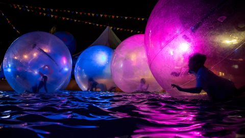 <strong>Richmond, British Columbia: </strong>Children float inside inflatable water walking balls in a pool at the Richmond Night Market in the Canadian city of Richmond in August. 