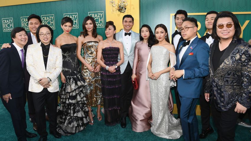 HOLLYWOOD, CA - AUGUST 07:  (L-R) The cast of "Crazy Rich Asians" Ken Jeong, Jon M. Chu, Jimmy O. Yang, Sonoya Mizuno, Gemma Chan, Michelle Yeoh, Henry Golding, Awkwafina, Constance Wu, Chris Pang, Nico Santos, Ronny Chieng, and author Kevin Kawn arrive at Warner Bros. Pictures' "Crazy Rich Asians" Premiere at TCL Chinese Theatre IMAX on August 7, 2018 in Hollywood, California.  (Photo by Emma McIntyre/Getty Images)