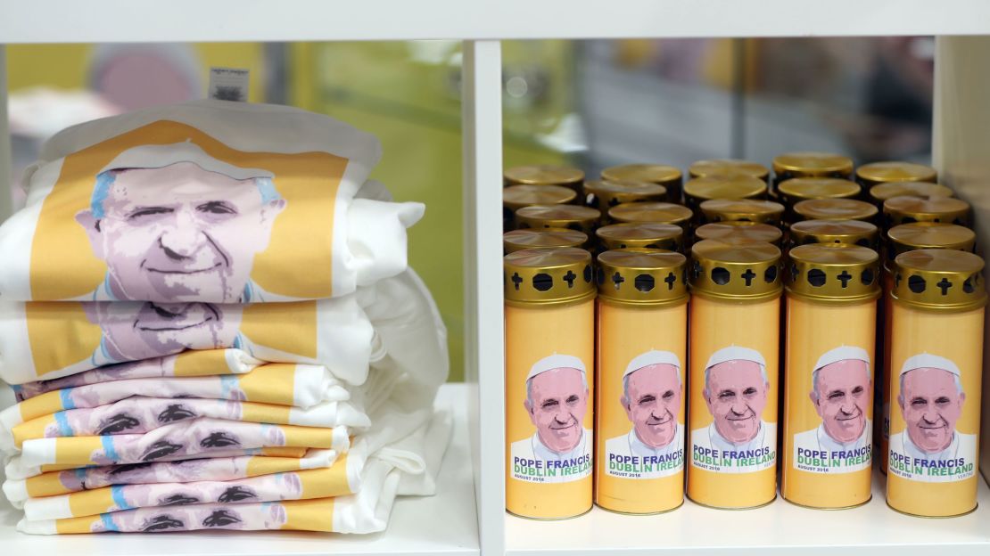 Pope Francis-themed T-shirts and candles are seen on sale before the opening ceremony of the World Meeting of Families in Dublin.