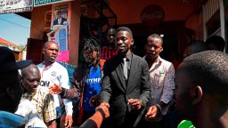 Musician turned politician, Robert Ssentamu Kyagulanyi commonly known as "Bobi wine" (C) shakes hands with his supporters in a suburb of Kampala on June 30, 2017. 