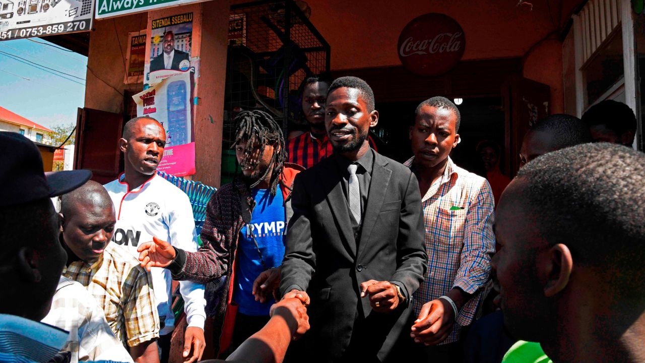 Musician turned politician Robert Kyagulanyi -- commonly known as Bobi Wine -- shakes hands with supporters in a suburb of Kampala on June 30, 2017. 