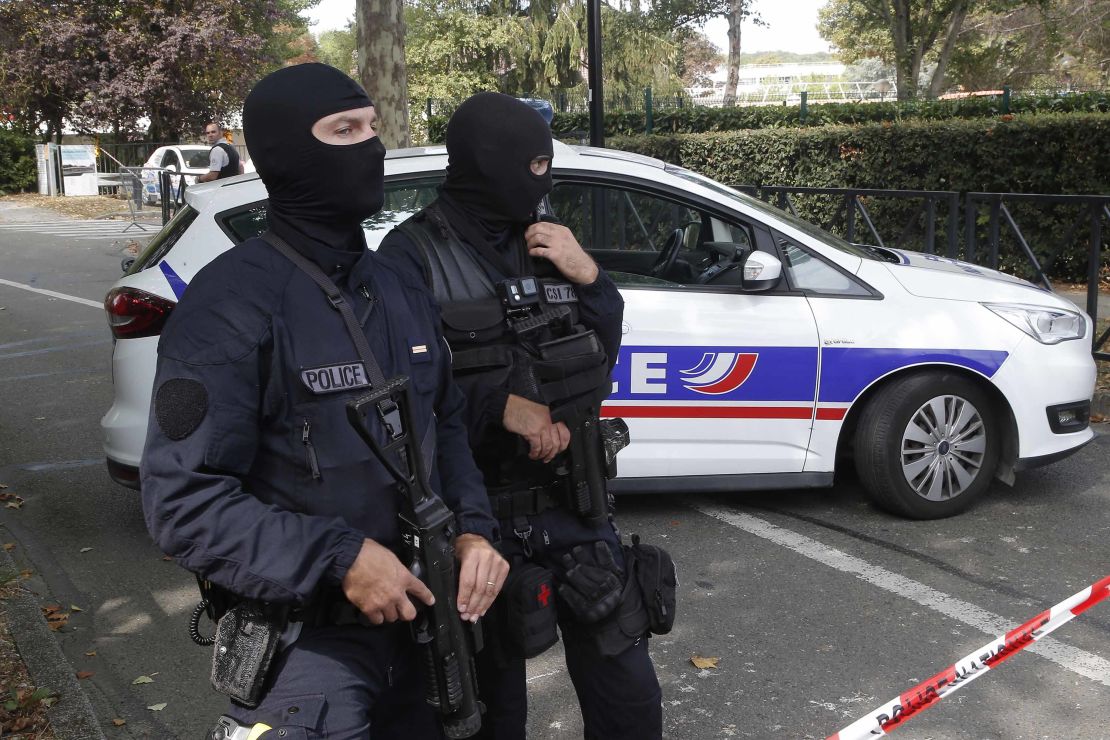 French police officers cordon off the area after a knife attack on Thursday in Trappes.