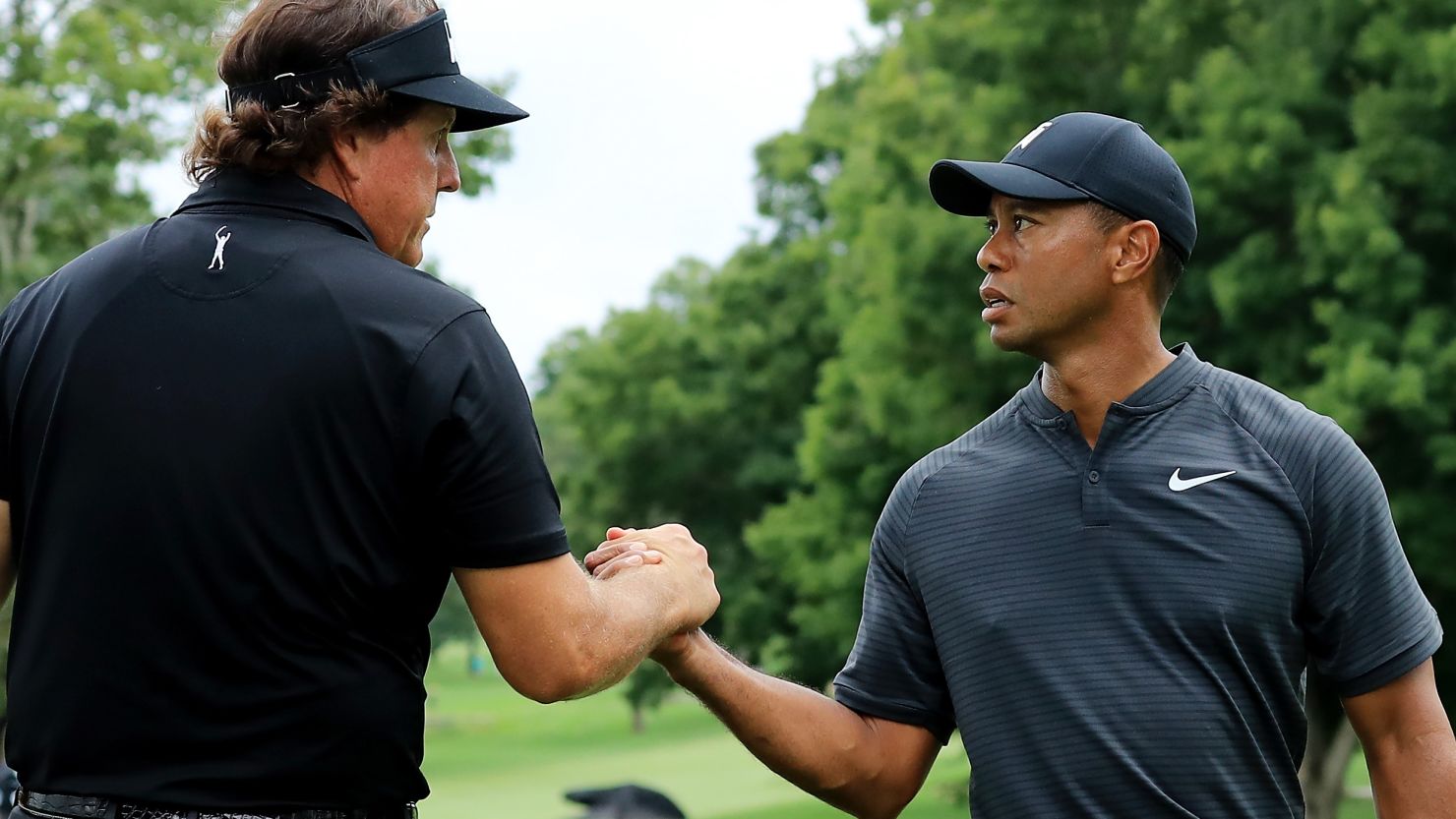 Phil Mickelson and Tiger Woods meet during a preview day of the World Golf Championships in Akron, Ohio, earlier in August.  