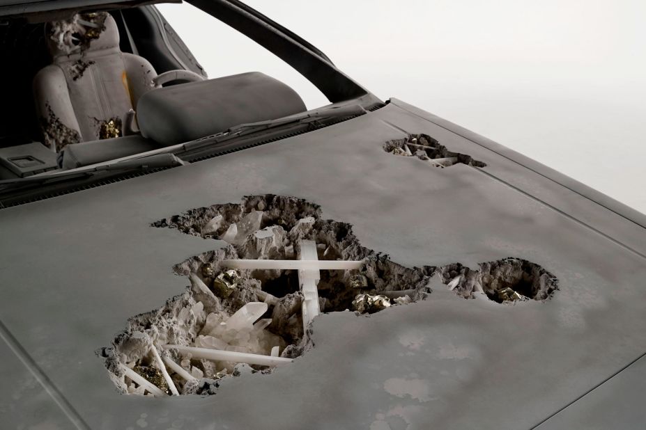 Deep cavities in the car's chassis reveal clusters of pyrite crystals.