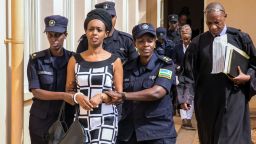 Diane Rwigara (C), a prominent critic of Rwanda's President Paul Kagame, is escorted by Police officers to the court room at the Nyarugenge intermediate court in Kigali on October 9, 2017. 
Rwigara was blocked from challenging Kagame in August's presidential election and she had been charged with inciting insurrection against the state as well as other offences. The court is to rule on whether Rwigara, her mother and sister should be held in preventive detention. 

 / AFP PHOTO / Cyril Ndegeya        (Photo credit should read CYRIL NDEGEYA/AFP/Getty Images)