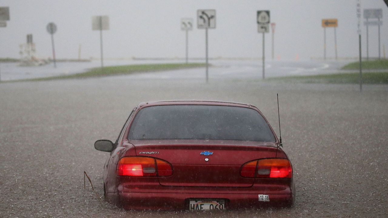  A car is partially submerged in water from Hurricane Lane rainfall on the Big Island on Thursday. 