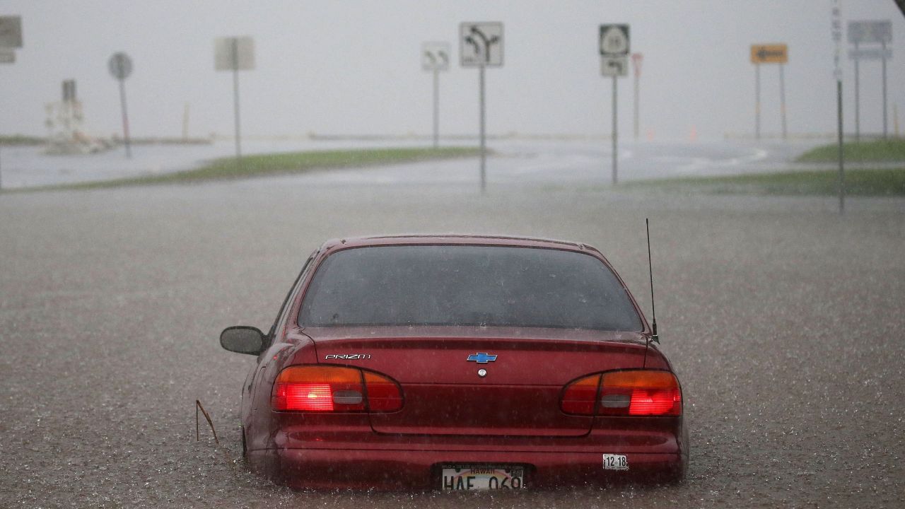A car is partially submerged in water from Hurricane Lane rainfall on the Big Island on Thursday.