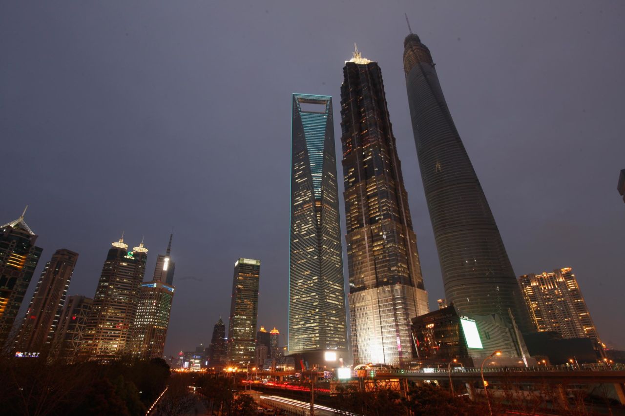 <strong>2. Shanghai Tower (Shanghai):</strong> The Shanghai Tower, lit up in blue, is notable not only for its dizzying height (the tallest building in China) but for its green sustainability.
