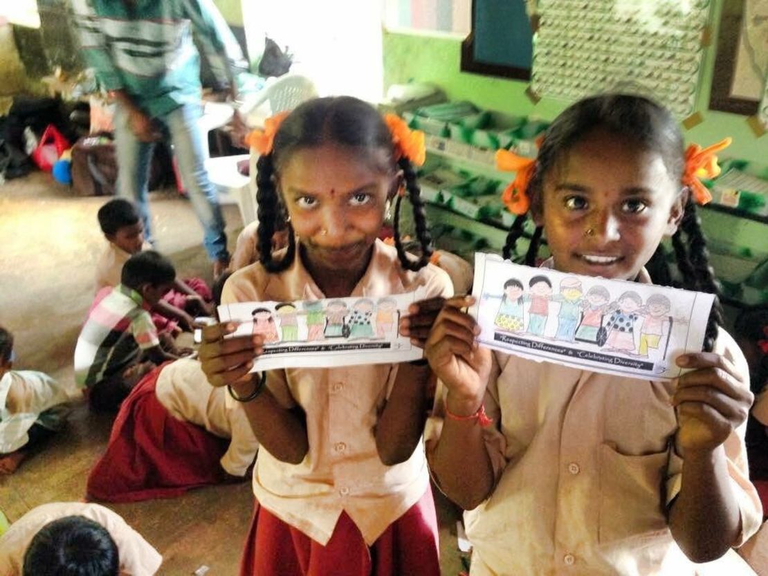 Girls from a Dark is Divine session holding their drawings to celebrate skin tone diversity in Tamil Nadu, India.