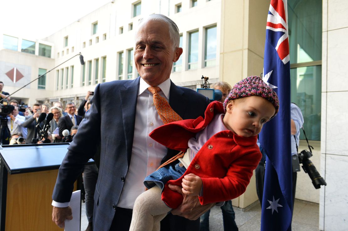 Australia's outgoing Prime Minister Malcolm Turnbull leaves his last press conference with his granddaughter Alice in Canberra on August 24.