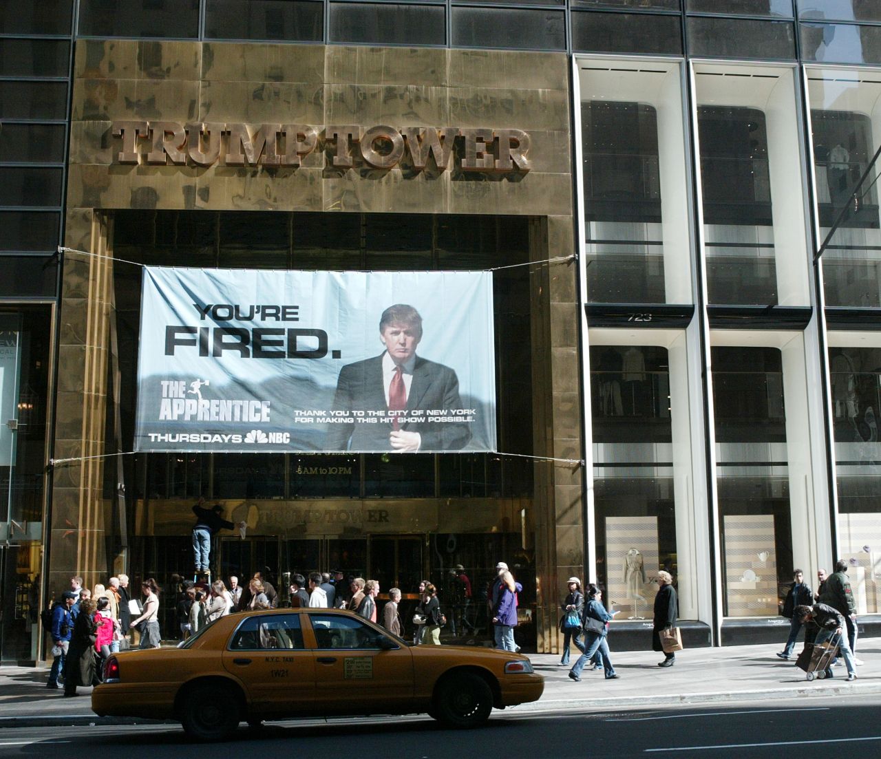 An advertisement for the television show "The Apprentice" hangs at Trump Tower in 2004. The show launched in January of that year. In January 2008, the show returned as "Celebrity Apprentice."