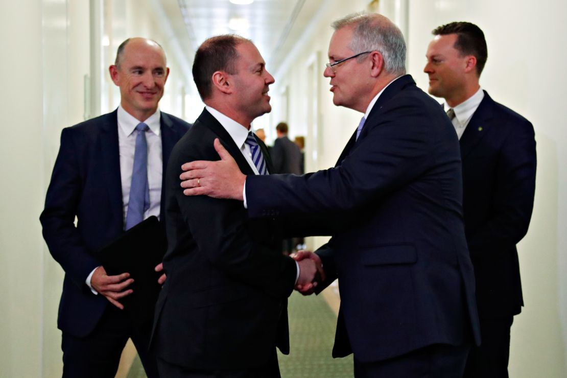 Australia's incoming Prime Minister Scott Morrison (2nd R) is congratulated by his new deputy Josh Frydenberg (2nd L) after a party meeting in Canberra on August 24.