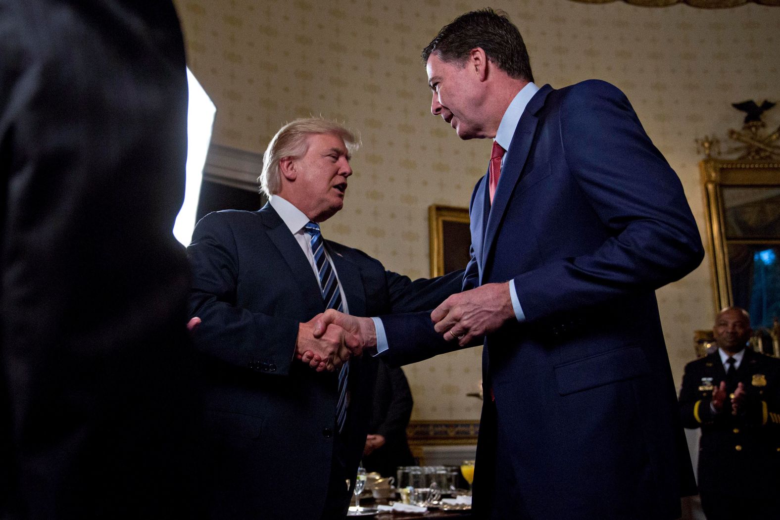 Trump shakes hands with FBI Director James Comey during a White House reception in January 2017. <a href="index.php?page=&url=http%3A%2F%2Fwww.cnn.com%2F2017%2F05%2F09%2Fpolitics%2Fjames-comey-fbi-trump-white-out%2Findex.html" target="_blank">Trump fired Comey</a> a few months later, sweeping away the man who was responsible for the FBI's investigation into whether members of Trump's campaign team colluded with Russia in its election interference. The Trump administration attributed Comey's dismissal to his handling of the investigation into Hillary Clinton's email server.