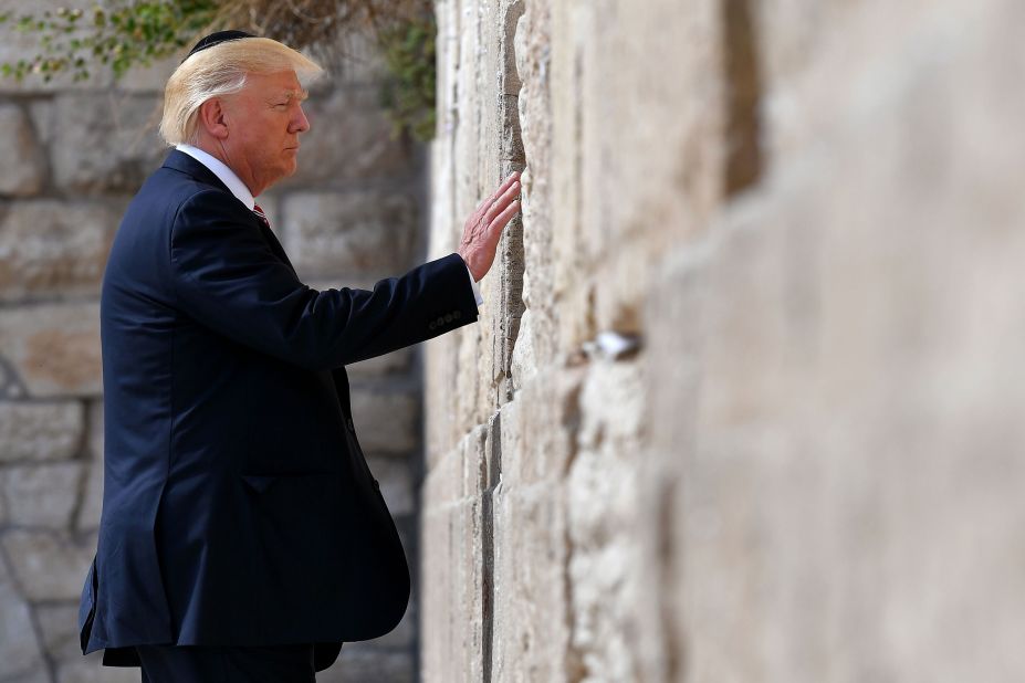 Trump touches the Western Wall, Judaism's holiest prayer site, while in Jerusalem in May 2017. Trump became <a href=