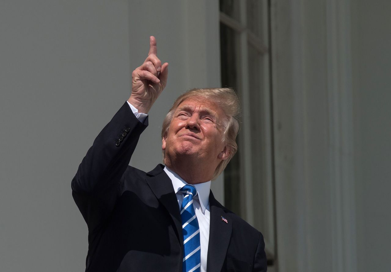Trump <a href="http://www.cnn.com/2017/08/21/politics/trump-solar-eclipse/index.html" target="_blank">looks up at the sky</a> during the total solar eclipse in August 2017. He eventually put on protective glasses as he watched the eclipse with his wife and their son from the White House South Portico.