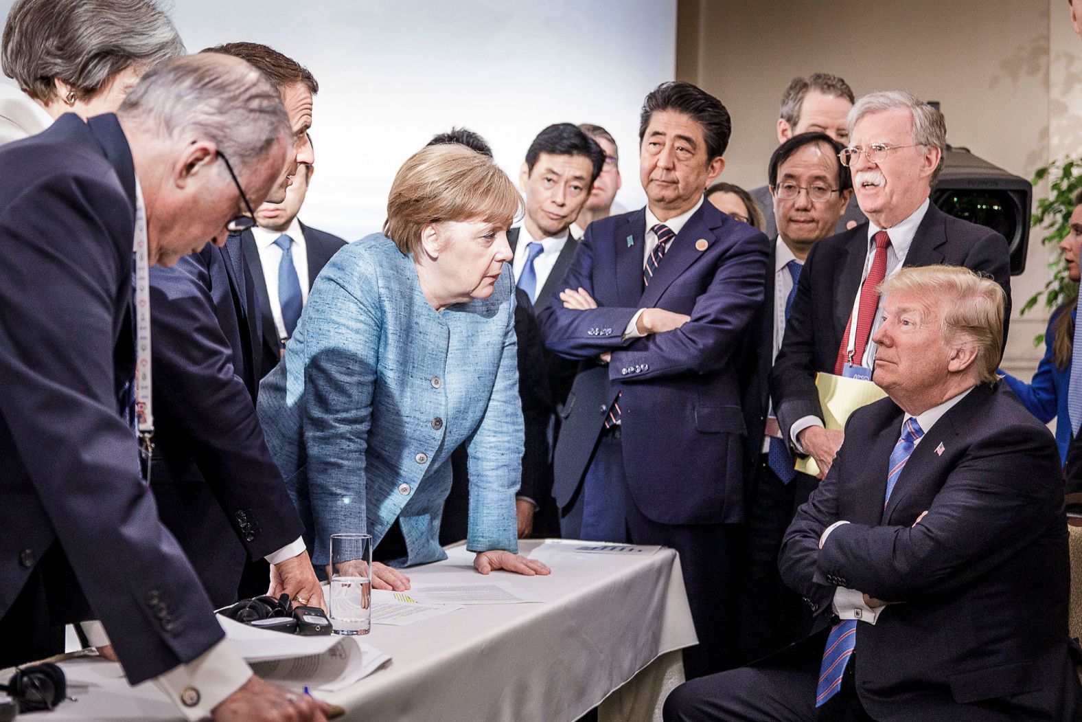 In this photo provided by the German Government Press Office, German Chancellor Angela Merkel talks with a seated Trump as they are surrounded by other leaders at the G7 summit in Charlevoix, Quebec, in June 2018. According to two senior diplomatic sources, <a href="index.php?page=&url=https%3A%2F%2Fwww.cnn.com%2F2018%2F06%2F11%2Fpolitics%2Fg7-photo%2Findex.html" target="_blank">the photo was taken</a> when there was a difficult conversation taking place regarding the G7's communique and several issues the United States had leading up to it.
