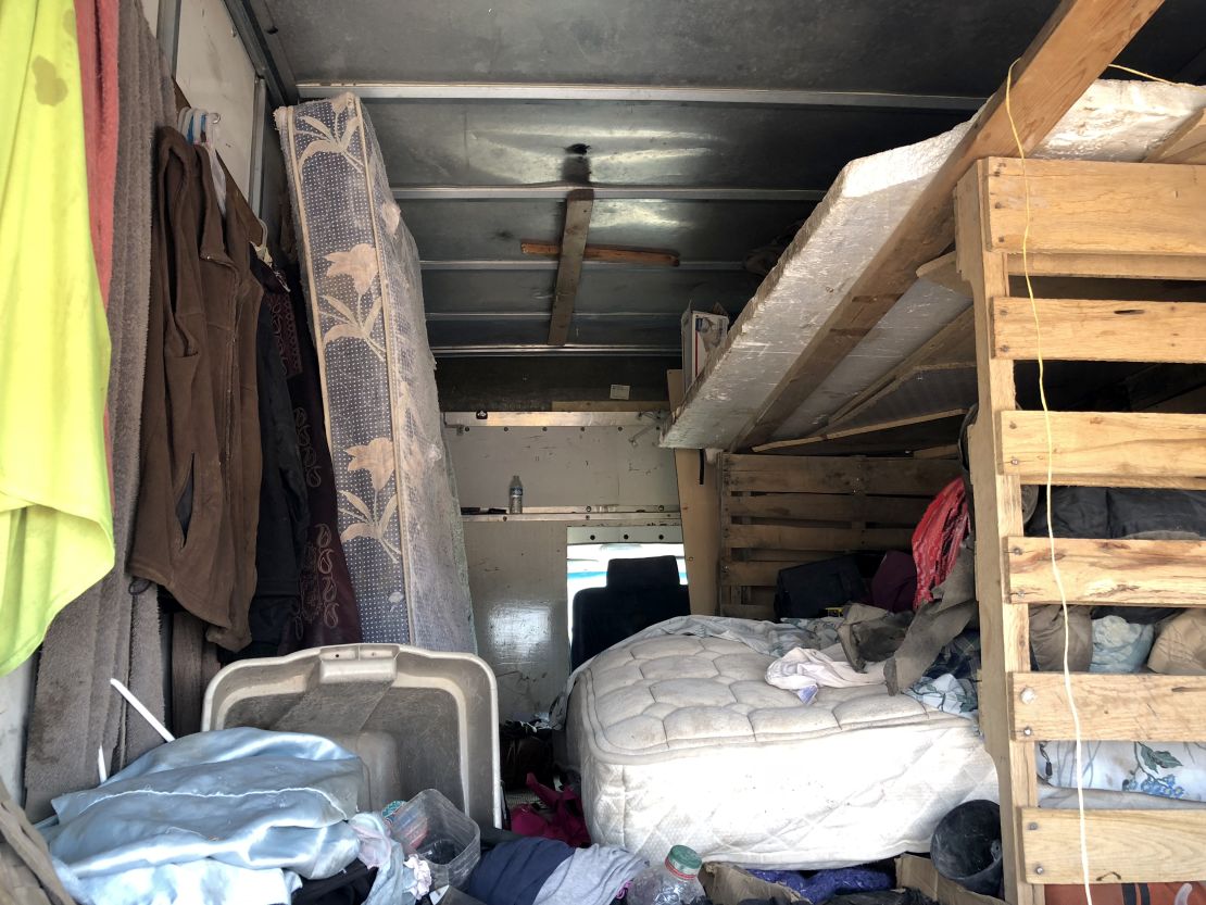 Makeshift living quarters in a box truck remain on the compound.