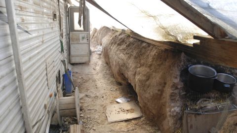 Authorities found a trailer on the compound containing dirty clothing, dishes, weapons and ammunition.