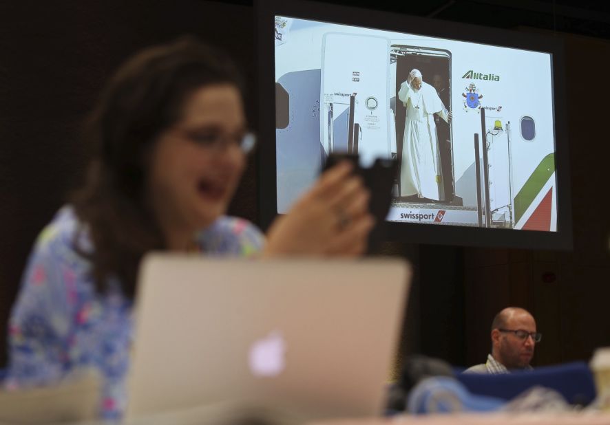 A journalist reacts inside the media center as Pope Francis arrives at Dublin Airport on Saturday.