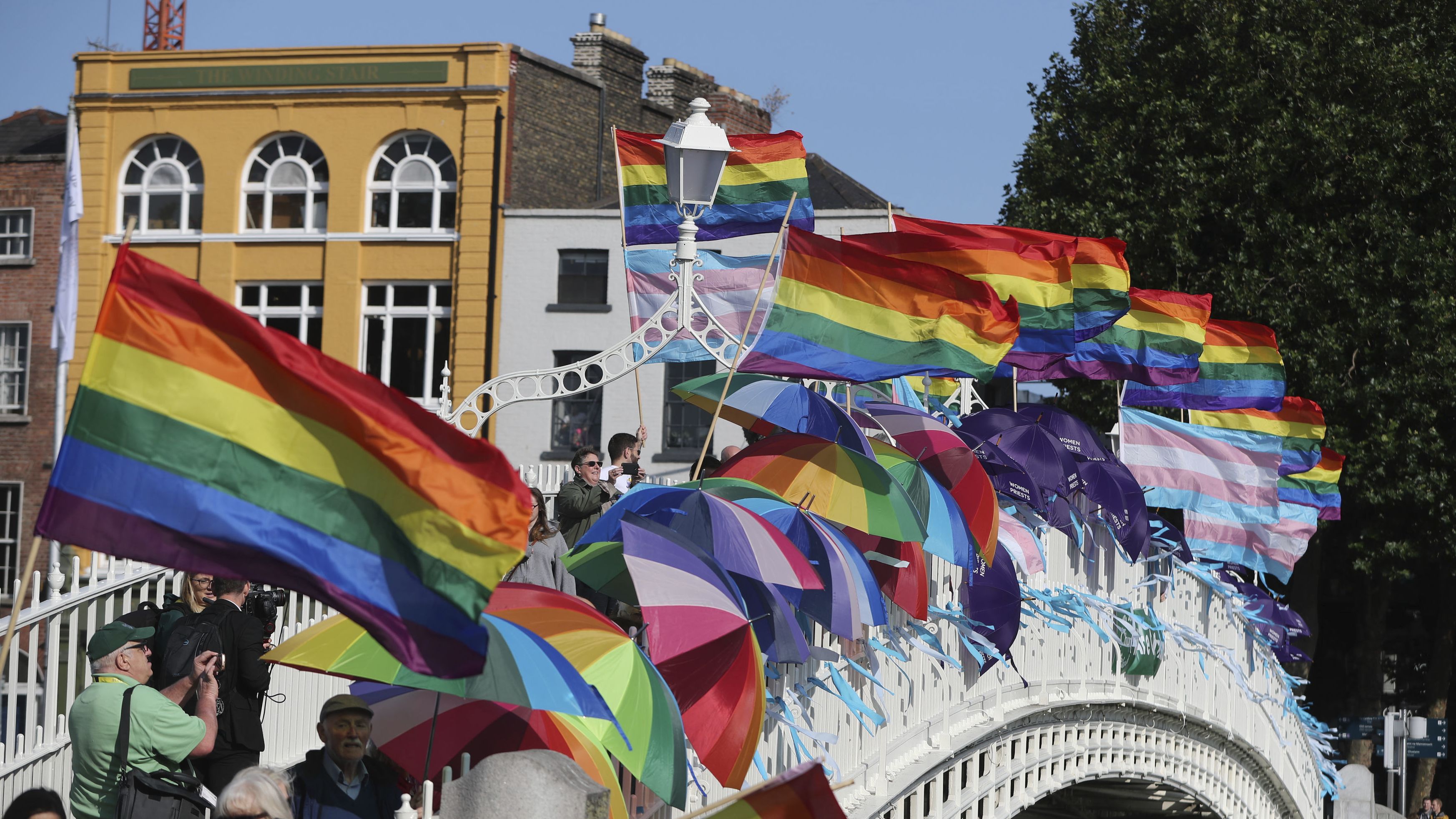 Rainbow flags and blue ribbons are tied to Ha'penny Bridge in Dublin to remember the victims of Catholic Church clerical sex abuse.