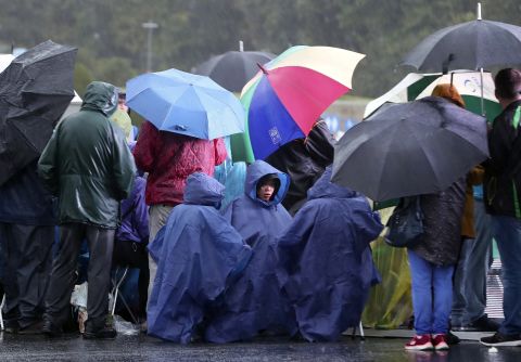 People wait for the arrival of Pope Francis in front of the Knock Shrine on Sunday.