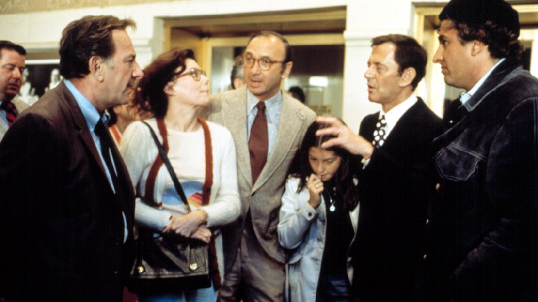 Neil Simon, center, visits the set of "The Odd Couple," with former wife, Marsha Mason, in 1974.