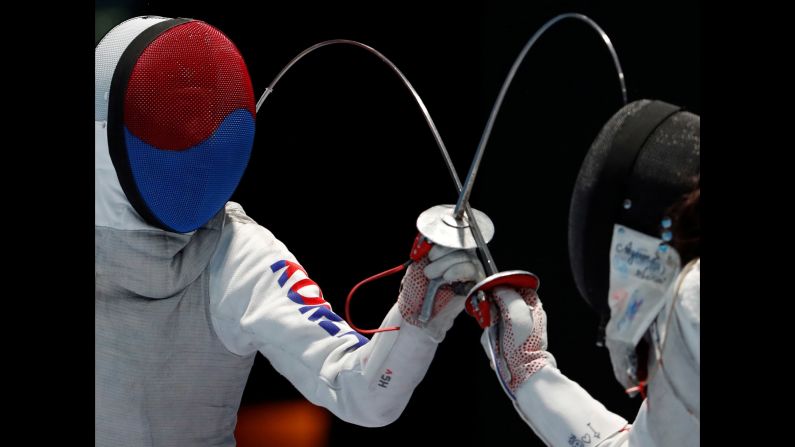 South Korean fencer Jeon Hee-sook, left, competes against Japan's Sera Azuma during the Asian Games on Monday, August 20.