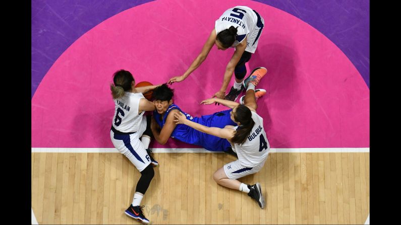Thai basketball player Thidaporn Maihom is surrounded by Mongolian players during the Asian Games on Thursday, August 23.