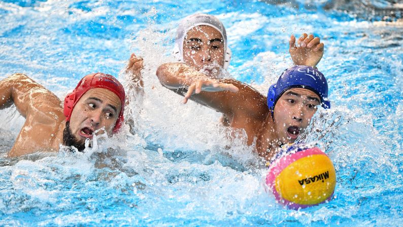 Japan's Katsuyuki Tanamura, left, and China's Liu Xiao swim to the ball during an Asian Games water-polo match on Saturday, August 25.