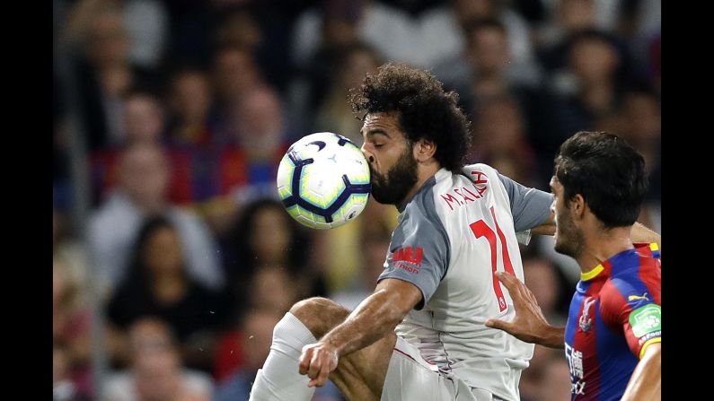 The ball smashes into the face of Liverpool's Mohamed Salah during a Premier League match in London on Monday, August 20.