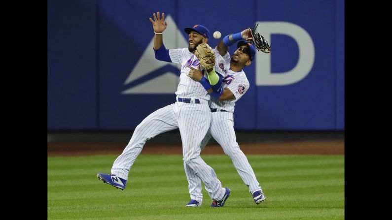 New York Mets teammates Amed Rosario, left, and Dominic Smith collide while trying to catch a pop fly on Monday, August 20. The collision came in the 13th inning and allowed San Francisco to score what proved to be the game-winning run.