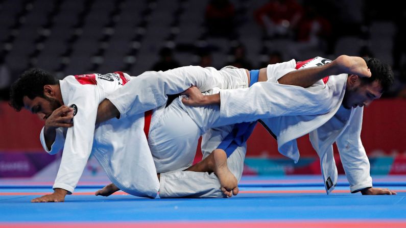 Talib al-Kirbi of the United Arab Emirates competes against Torokan Bagynbai Uulu of Kyrgyzstan in a gold-medal ju-jitsu match at the Asian Games on Friday, August 24. Bagynbai Uulu came out on top.