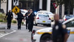 Police gather after an active shooter was reported at the Jacksonville Landing in Jacksonville, Fla., Sunday, Aug. 26, 2018. A gunman opened fire Sunday during an online video game tournament that was being livestreamed from a Florida mall, killing multiple people and sending many others to hospitals. (AP Photo/Laura Heald)